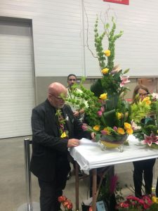 Neville MacKay judges a centerpiece; photo by Gord Fulton