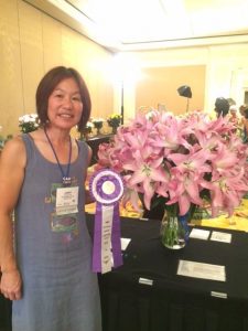 Green Valley's Janet Louie poses with her winning lily. 