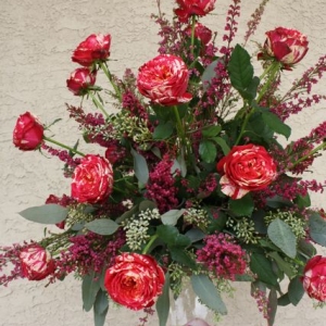 Tall glass pedestal centerpiece for wedding with Eufloria roses