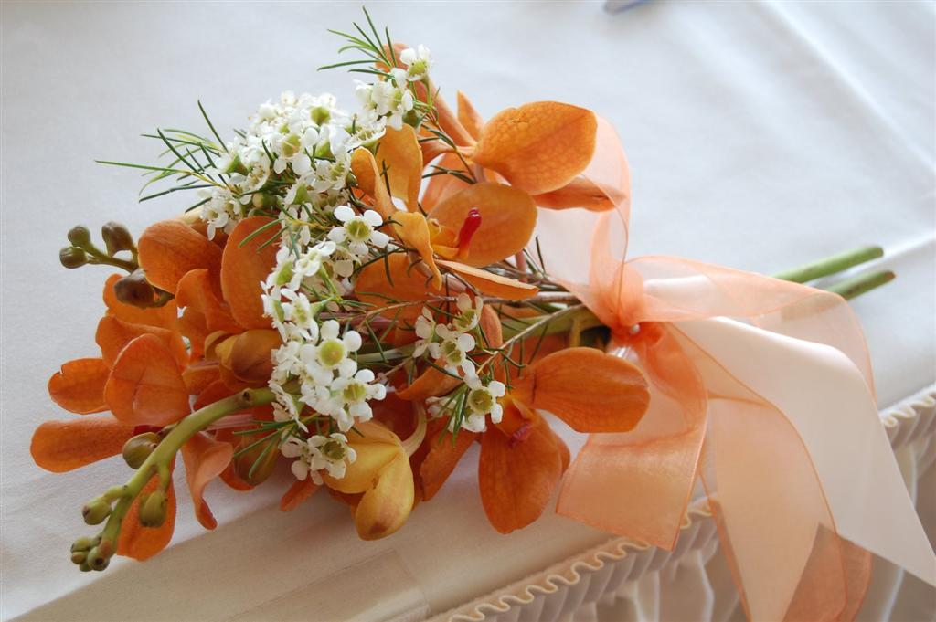 Hand tied orchids with waxflower